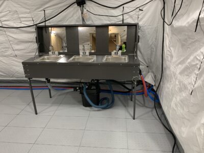 sinks with mirrors in a tent