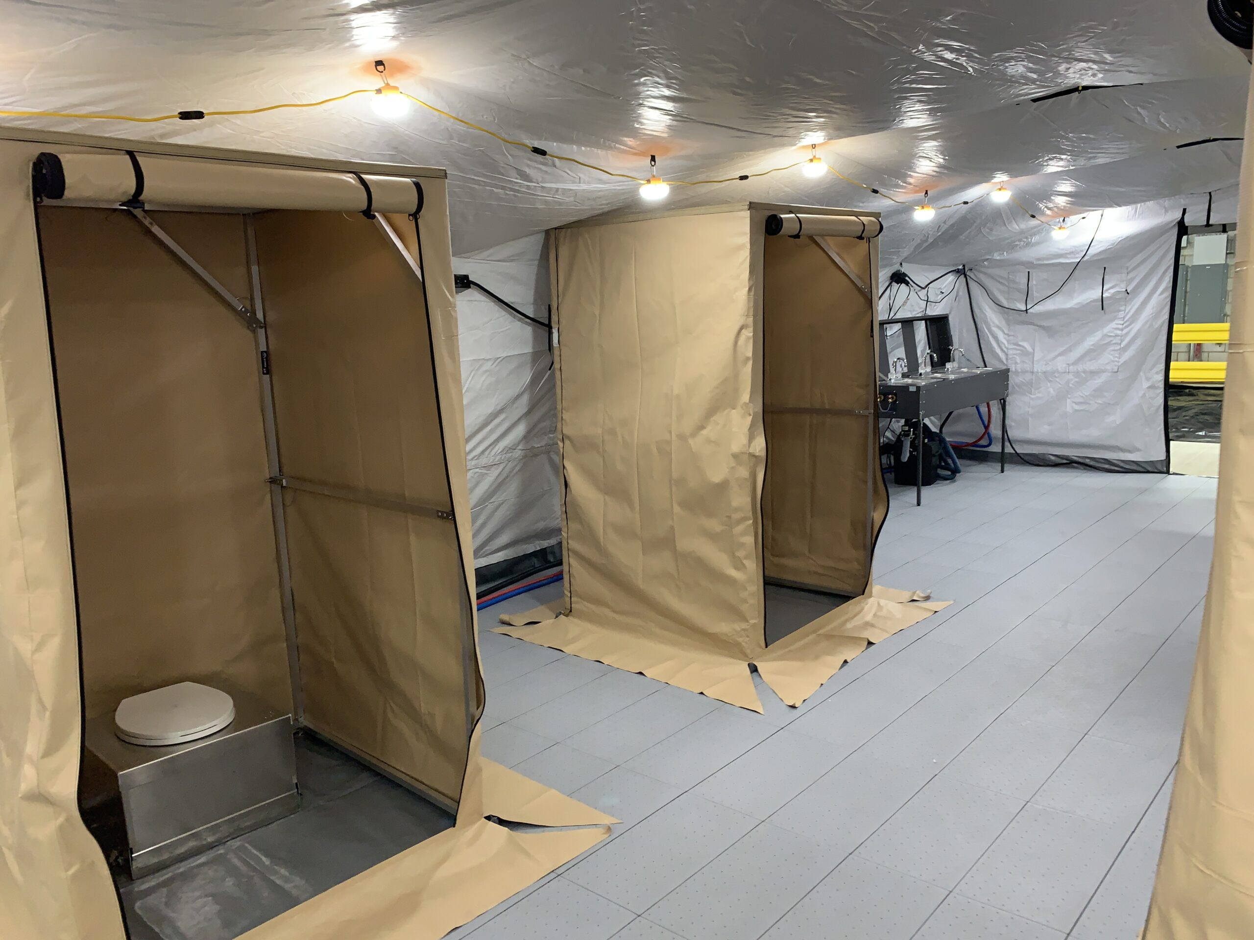 individual toilet stalls in a tent