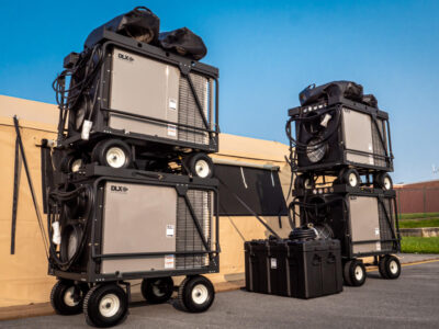 stacked equipment with tent in field