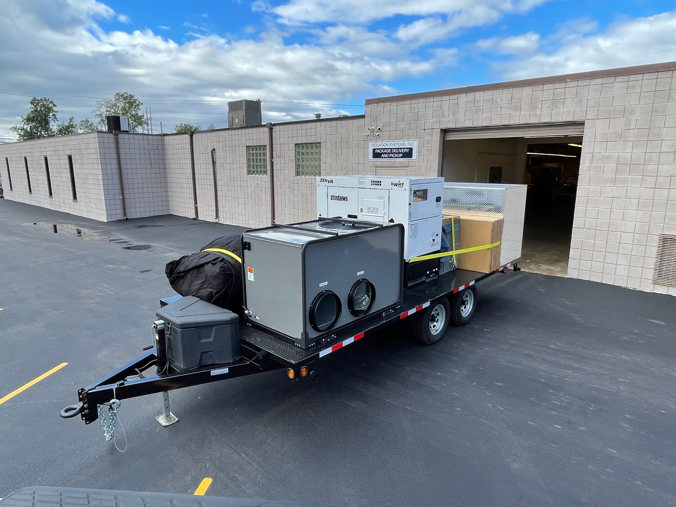 custom trailer in front of industrial garage