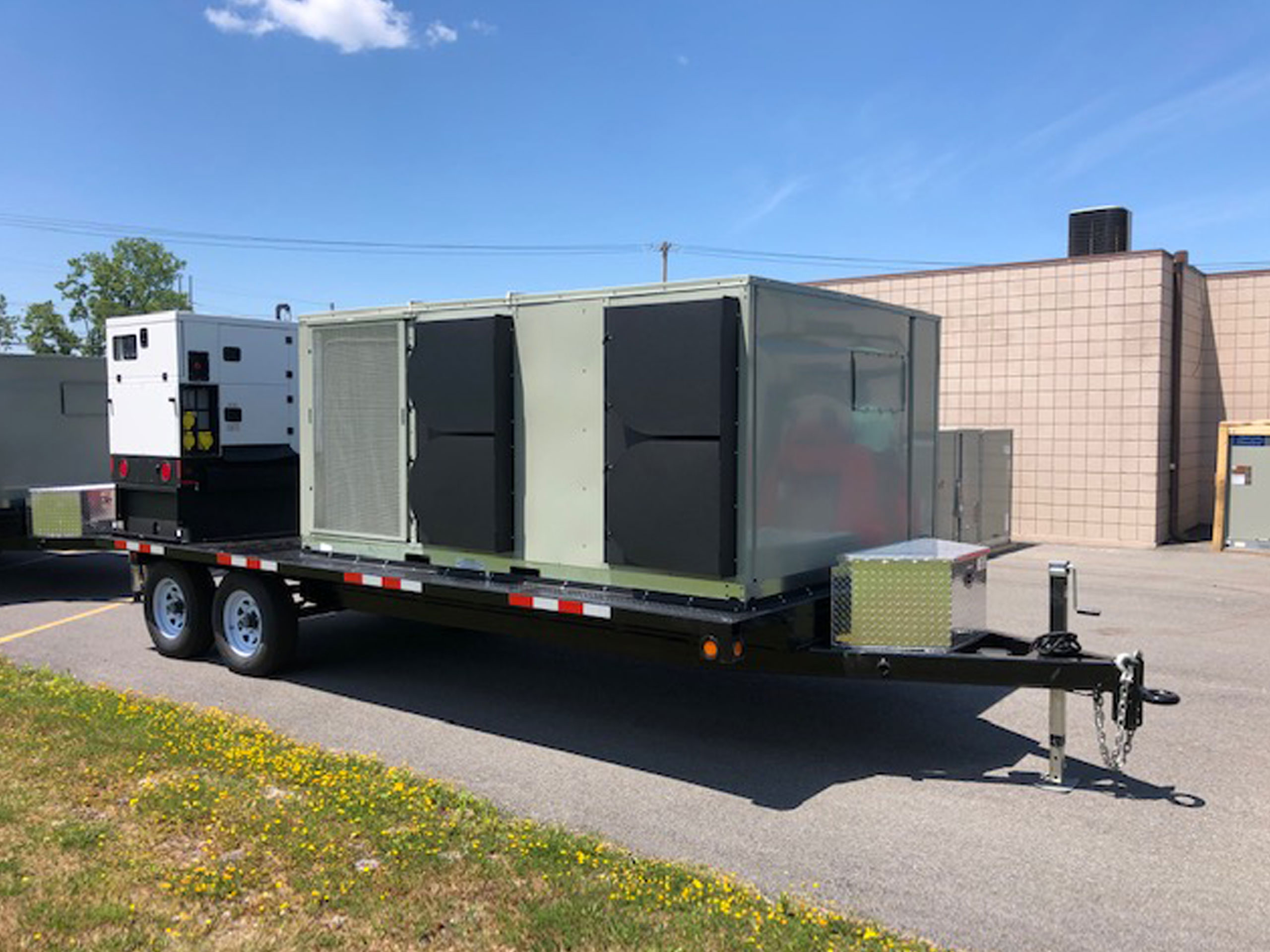 custom trailer in front of industrial garage