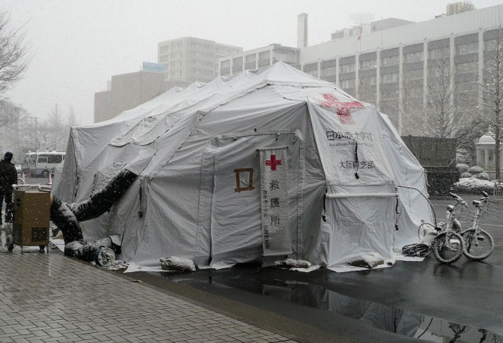 medical tent in front of industrial building